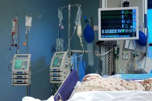 ICU room in a hospital with medical equipments and a patient